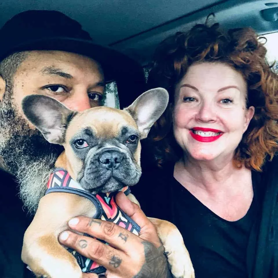 Couple taking a selfie with a fawn French Bulldog puppy